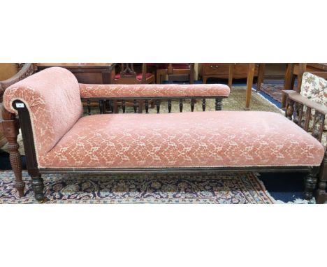 A Victorian mahogany framed chaise longue with pink Damask upholstery on turned supports terminating in ceramic casters, 71cm