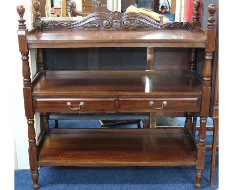 A 20th century mahogany three tier buffet with two drawers to central tier on turned uprights, 115cm high x 110cm wide x 44cm
