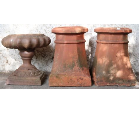 A lot comprising two early 20th century terracotta octagonal chimney pots, 47cm high x 33cm wide x 33cm deep and a stoneware 