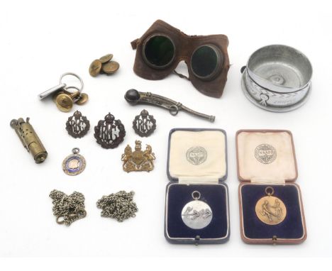 A pair of pilot's flying goggles; a bosun's whistle stamped "J. Munro"; three Royal Flying Corps (RFC) cap badges; cased Navy