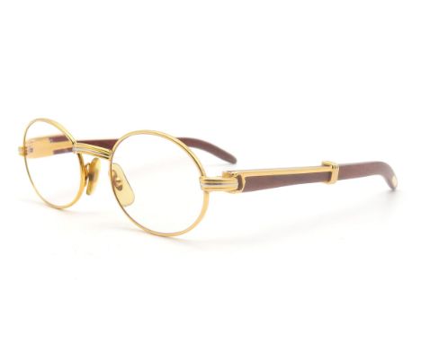 A pair of Cartier gold-tone glasses, with wooden temples, the bridge marked "Cartier 49 20", the temples numbered 130b Condit