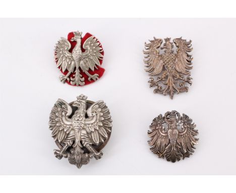 Four various pre-War Polish army eagle badges