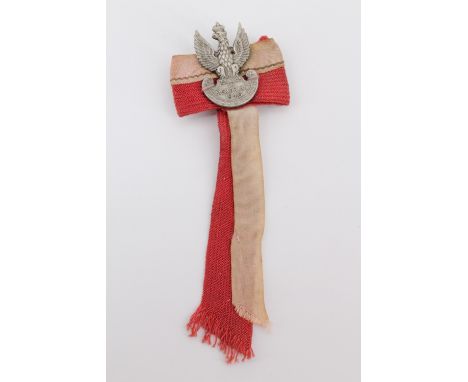 An "In Memoriam 1940" Polish commemorative in the form of a miniature army cap badge with  ribbons in national colours