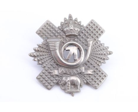 An early 20th Century Highland Light Infantry cap badge, the bugle device voided and having the numerals 71 inset