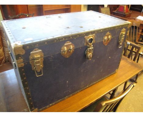 Vintage rectangular canvas trunk with metal banding and stud work and leather carrying handles. 