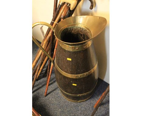 Large coopered oak brass mounted baluster shaped jug with loop handle, used as a stick stand. 