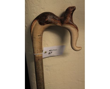 Rustic shepherd's crook type walking stick, the handle carved with an otter.  CONDITION REPORT: General wear but no obvious d