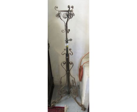 Cast metal scroll decorated lamp or oil burner stand on triform base. 