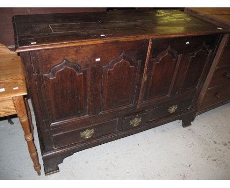 18th Century oak split coffer with arched panels and three fitted drawers on bracket feet. 