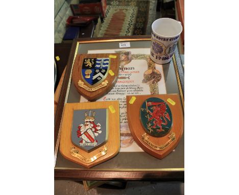 Three painted Welsh interest armorial wooden shields, a framed Welsh language Bardic certificate, framed coloured print after
