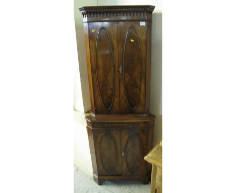 Reproduction mahogany blind panelled corner cupboard on bracket feet with pull out writing slope. 