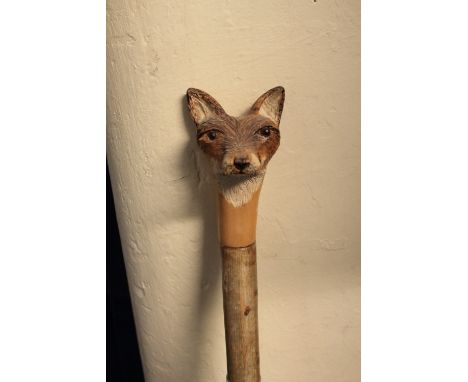 Rustic walking stick with carved mount in the form of a foxes head. 