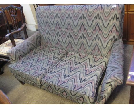Early 20th century geometrically upholstered two seater sofa on casters. 