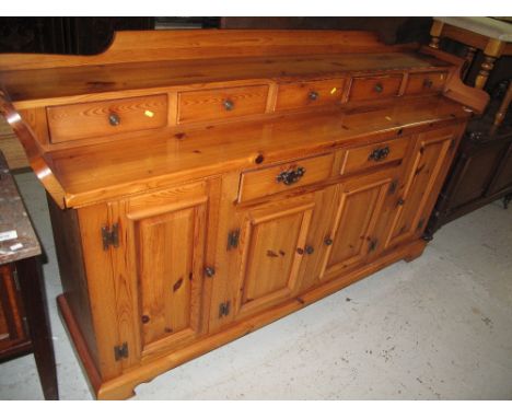 Modern pine sideboard with gallery top and fitted drawers on bracket feet. 