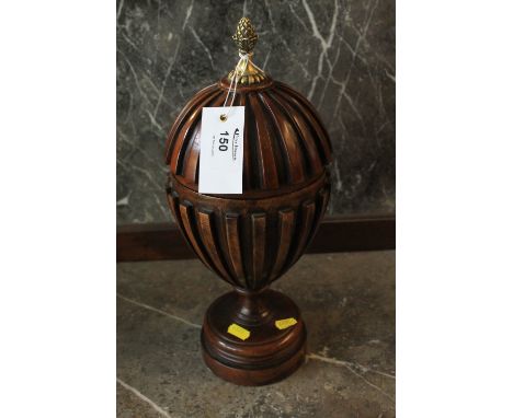 Moulded and turned hardwood pedestal urn with yellow metal finial and circular turned base. 