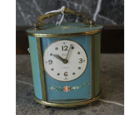 Mid 20th century Swiss oval section carriage clock design yellow metal and printed enamel alarm clock. 