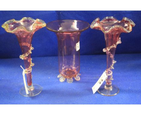 Victorian cranberry glass cylinder vase with flared neck together with a pair of Victorian cranberry glass trumpet vases with