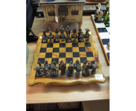 Walnut chess board with cast metal historical and other figures with two fitted drawers. 