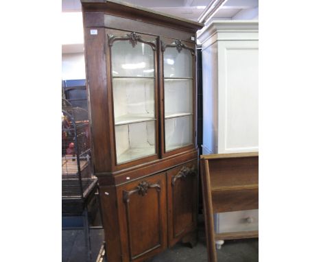 19th century oak two stage glazed corner cabinet on bracket feet. 