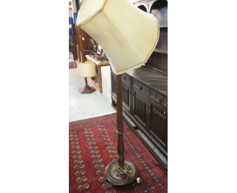 Mahogany standard lamp on circular base with fluted pedestal. 