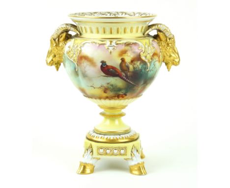 A Royal Worcester hand-painted twin handled pedestal vase Decorated with pheasants perching on a branch in landscape scene by