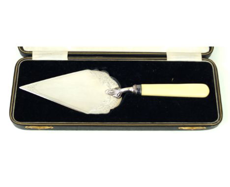 A George V silver and ivory handled trowelOf typical form, the trowel with engraved scroll and foliate detail, cased, loaded,