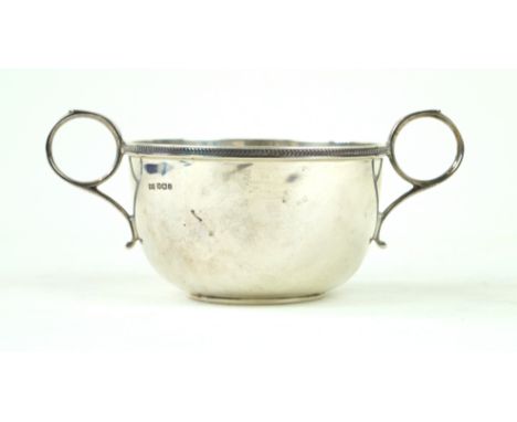 A George V silver two handled cupOf plain circular form, with an applied decorative rim, by Walker & Hall, Sheffield 1926, di