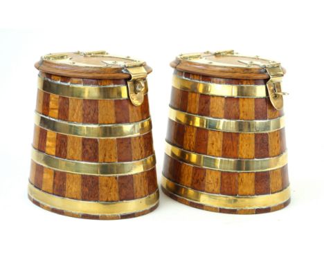 A pair of highly decorative brass bound oak storage boxes19th Century, each of tapering oval form, with medium and light oak 