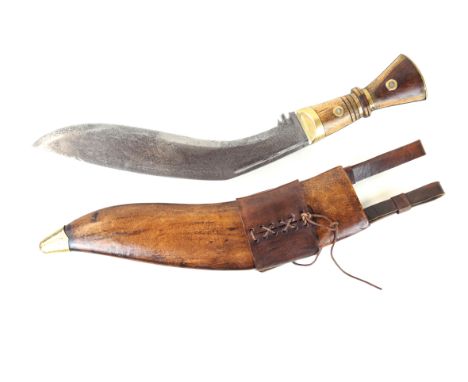 A late 20th Century period military issue Kukri knife 33cm curved blade stamped C01G II 1917, with wooden grip and brass fitt