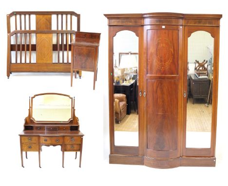 An Edwardian inlaid mahogany bedroom suiteComprising a three door wardrobe with central marquetry inlaid and box wood strung 