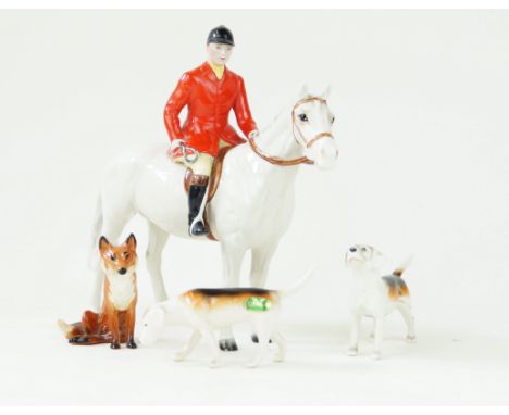 A Beswick ceramic four piece hunting setComprising huntsman on grey horse, height 21cm, fox and two hounds   CONDITION REPORT