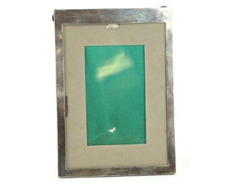 A George V silver photograph frameOf plain rectangular form, loaded, by Charles Perry & Co., Birmingham 1915, length 20.9cm  