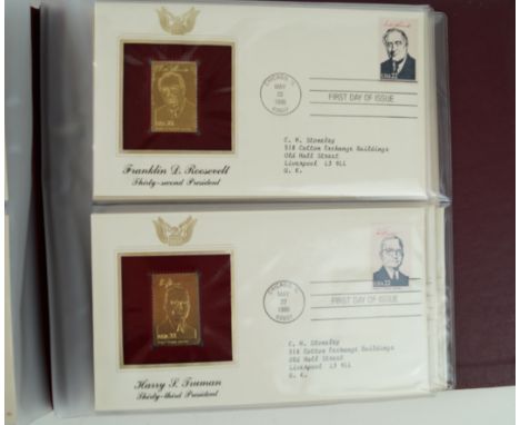 A large collection of stamps to include a few postcards,The stamps comprising five albums of golden replicas of United States