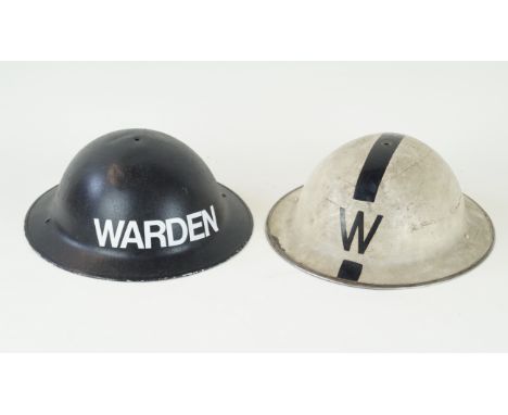 Two Warden Brodie Helmets, World War II periodThe first with white body with black W, the second with black body with white l