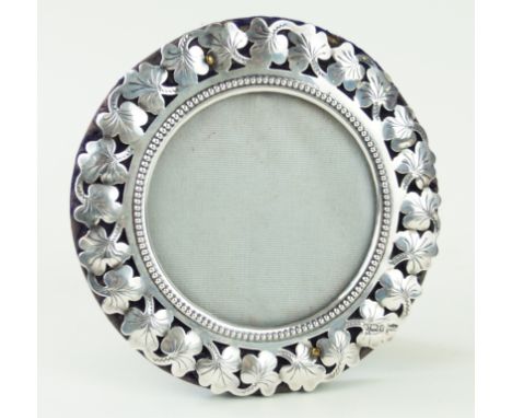 An Edwardian silver photograph frameOf circular form, with pierced shamrock and bead work decoration, loaded, by Walker & Hal