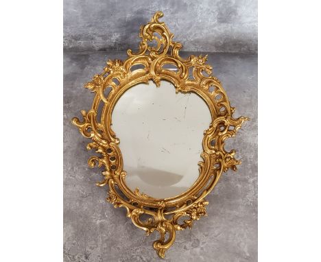A small gilt bronze cartouche shaped looking glass with bevelled and slightly foxed mirror plate in the Rococo manner, 20th c