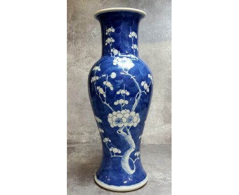 A 19th century Chinese underglaze blue and white baluster vase decorated with flowering prunus, double ring marks to base 30c