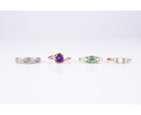 A collection of four 9ct gold stone set rings, comprising; an emerald and diamond example, size S, two opal rings, sizes S an
