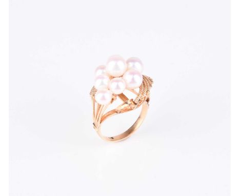 A graduated cultured pearl dress ring, designed as a cluster of eight cultured pearls set to decorative yellow metal mount, r