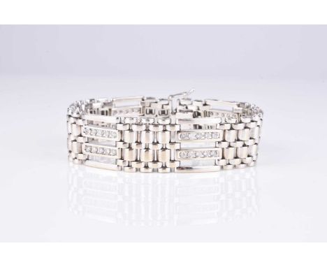 A diamond set gate link bracelet, designed as alternating diamond and brick links with integral push clasp, stamped '14k', 20