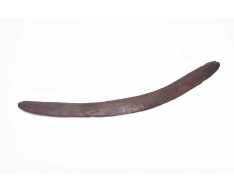 A hand-carved wooden boomerang, believed to be Australian (Aboriginal) 19th century, of typical form, with a rustic finish wi