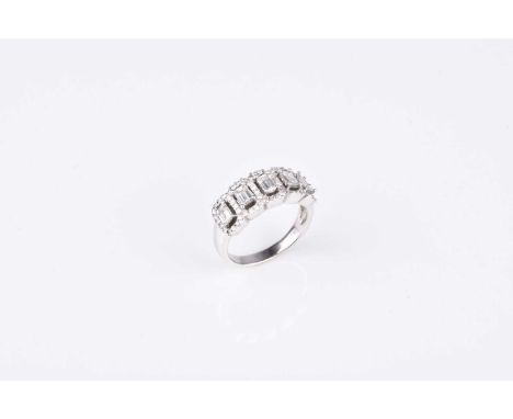A diamond dress ring, designed as five emerald cut diamonds claw set in white metal within borders of brilliant cut diamonds,