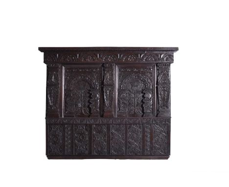 A 17th century and later carved oak part headboard or overmantelThe lunette carved cornice frieze above two recessed panels c