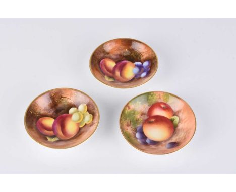 A set of three Royal Worcester miniature pin dishes painted with still lives of fruit, peaches and grapes, comprising one dat
