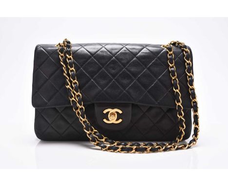 Chanel: A medium double flap Classic bagBlack quilted lambskin with gold toned hardware, leather and chain shoulder strap, ex