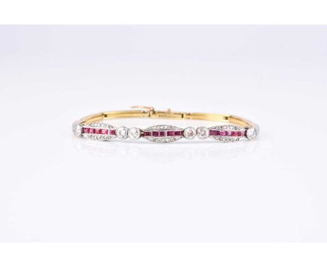 An early 20th century diamond and ruby bracelet, designed as three oval panels set with square cut rubies and rose cut diamon