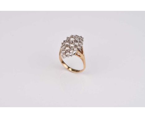 A graduated brilliant cut diamond cluster ring, of marquise form, the yellow metal shank stamped '14k', ring size R 1/2, weig