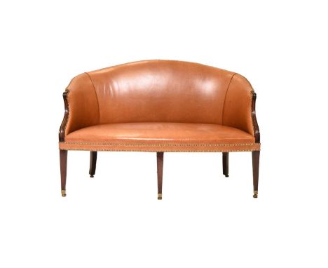 A George III mahogany and leather upholstered settee in the Hepplewhite style Raised on tapering square section supports capp