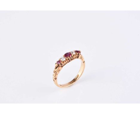 An 18ct gold five stone diamond and ruby ring, designed as a row of three graduated round mixed cut rubies interspersed with 