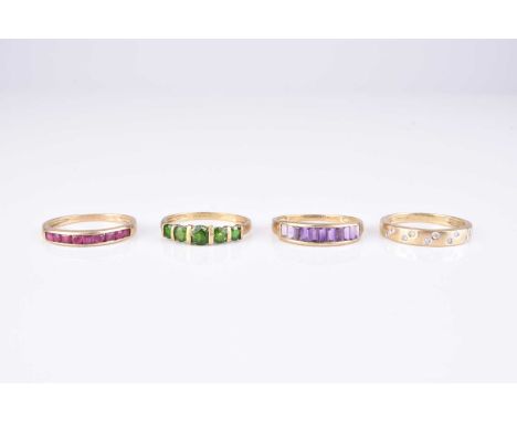 A collection of four 9ct gold stone set rings, comprising; an amethyst set band, size V, a ruby set band, size V, a diamond s